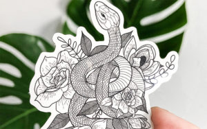 A photograph of Sarah May Arts' Floral Snake vinyl sticker.