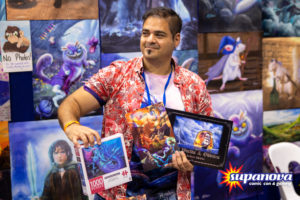 Anthony Christou holding some of his puzzles and work at Supanova 2021 - Gold Coast.