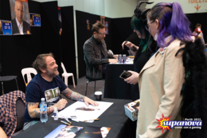 Mark Sheppard smiling, signing for fans (one dressed as Castiel from 'Supernatural') and Supanova 2022 - Perth.